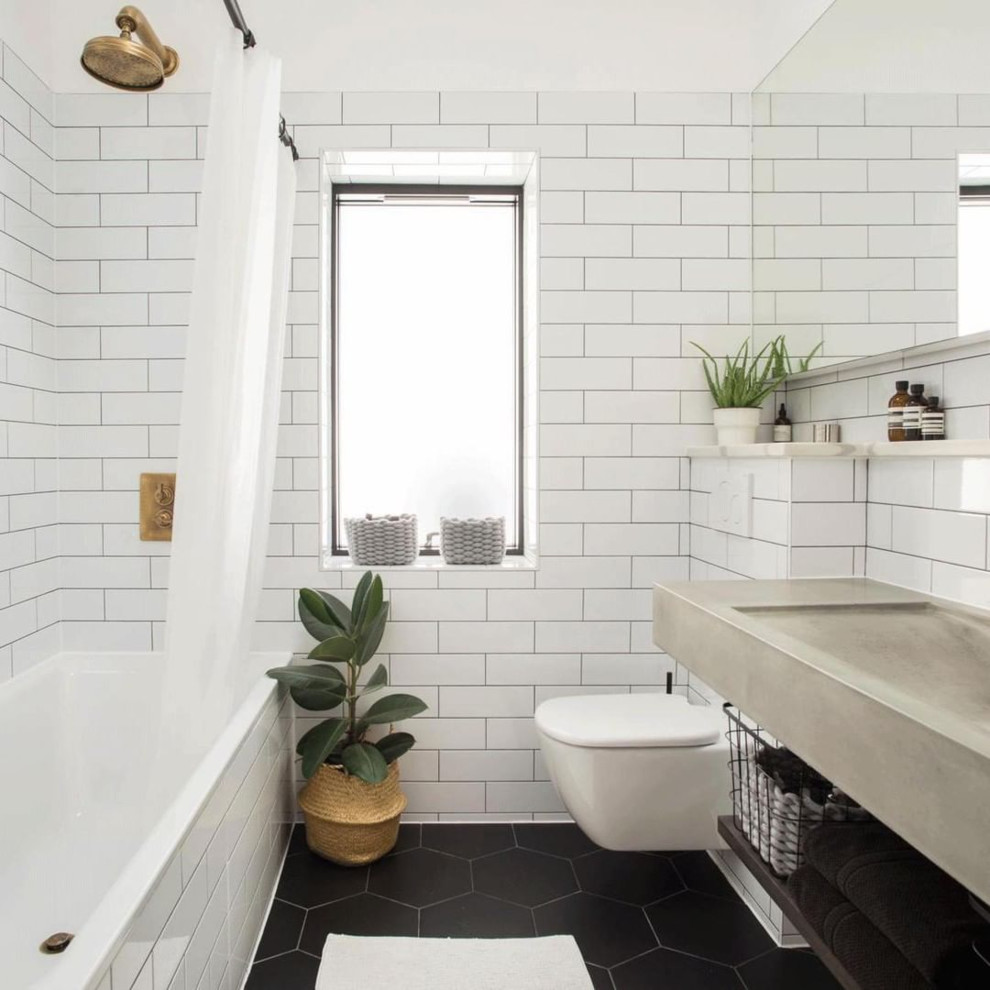 Contemporary bathroom in London with open cabinets, dark wood cabinets, a shower/bathtub combo, a wall-mount toilet, subway tile, an integrated sink, concrete benchtops, black floor, a shower curtain and grey benchtops.