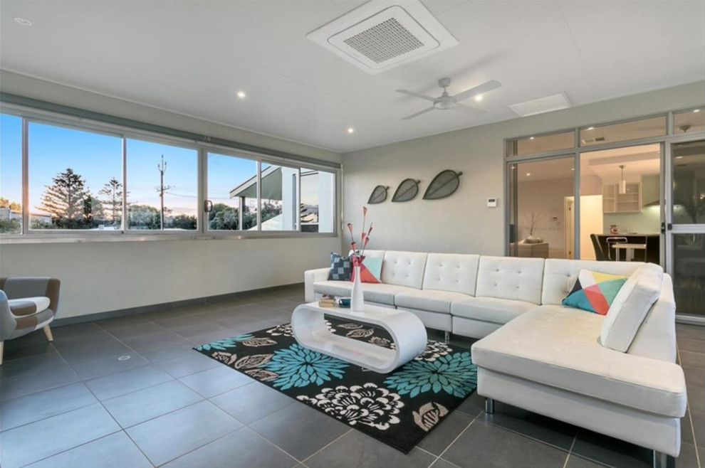 Photo of a mid-sized contemporary sunroom in Adelaide with ceramic floors, a standard ceiling and grey floor.