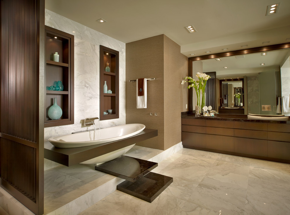 Inspiration for a contemporary bathroom in Miami with a drop-in sink, flat-panel cabinets, dark wood cabinets, granite benchtops, a drop-in tub, stone tile and white tile.