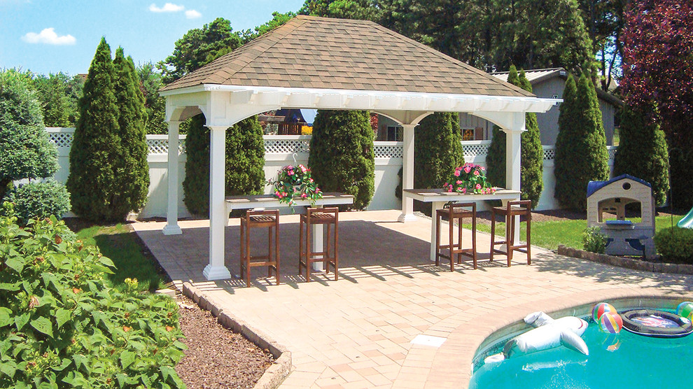 This is an example of a mid-sized traditional backyard patio in Philadelphia with brick pavers and a gazebo/cabana.