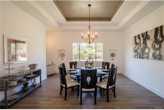 Mid-sized contemporary dining room in Los Angeles with white walls, medium hardwood floors and a ribbon fireplace.