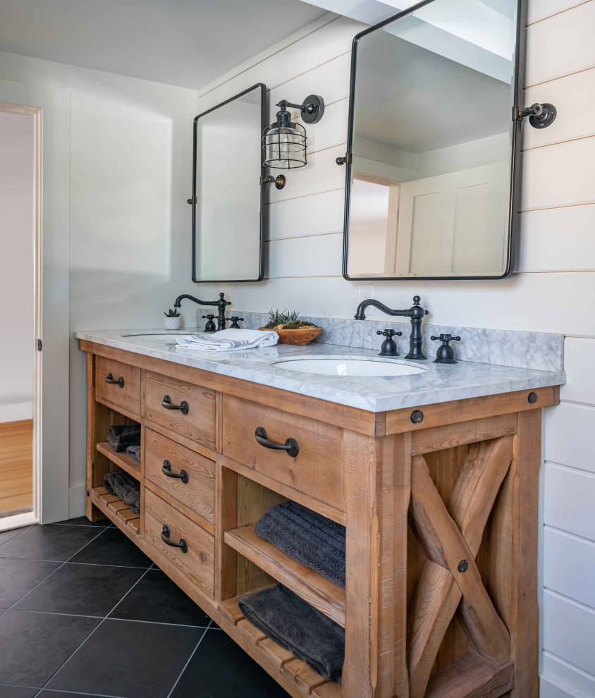 This is an example of a mid-sized country master bathroom in Boston with medium wood cabinets, white tile, subway tile, white walls, slate floors, an undermount sink, marble benchtops, grey floor, a hinged shower door, white benchtops, a double vanity, a built-in vanity and planked wall panelling.