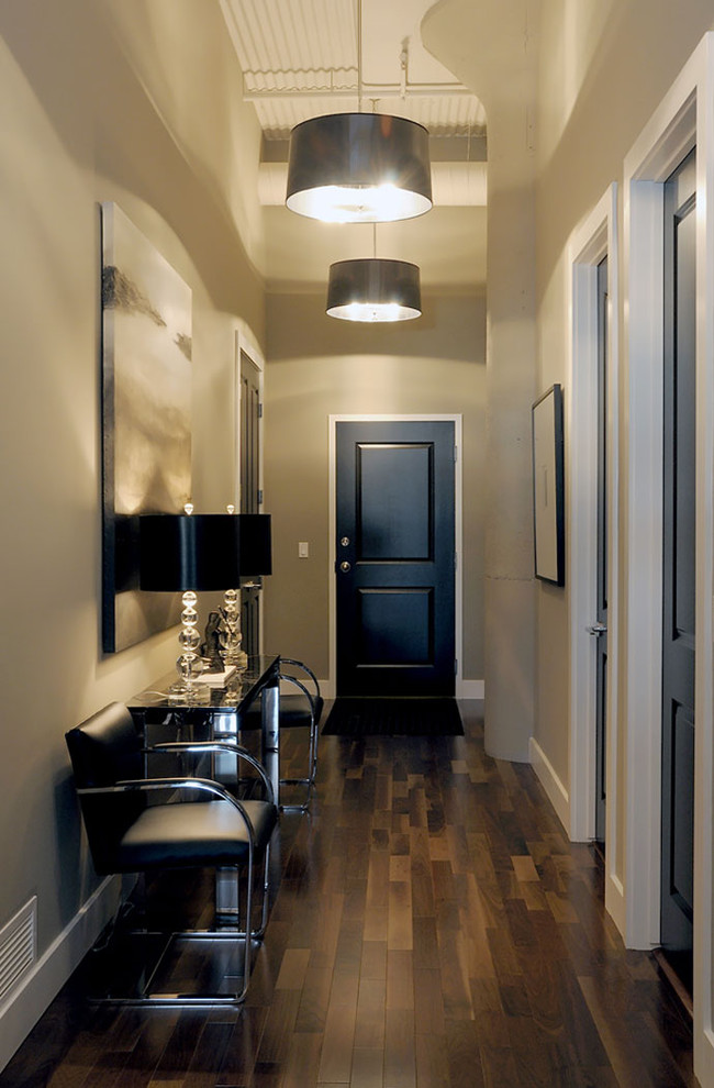 Photo of a transitional entry hall in Other with grey walls, dark hardwood floors, a single front door and brown floor.