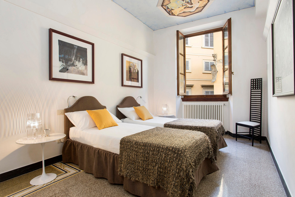 Photo of a small traditional guest bedroom in Florence with white walls, porcelain floors and multi-coloured floor.