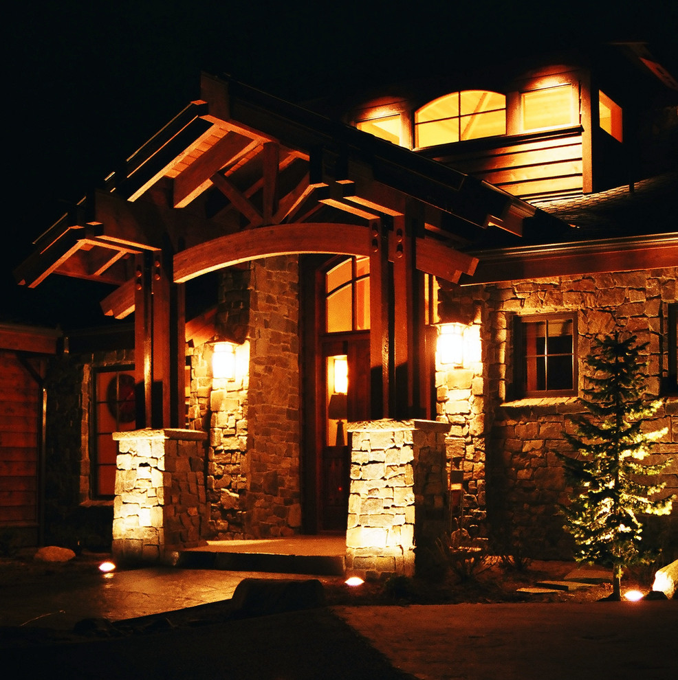 Large country two-storey brown exterior in Seattle with stone veneer.