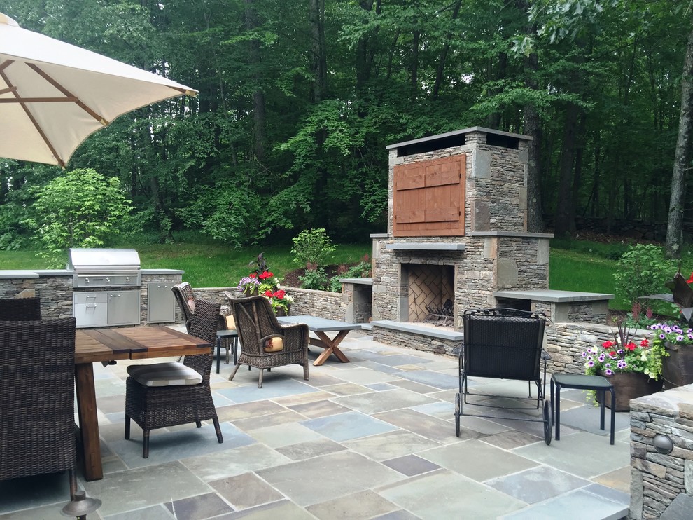 Photo of a mid-sized traditional backyard patio in New York with a fire feature and natural stone pavers.