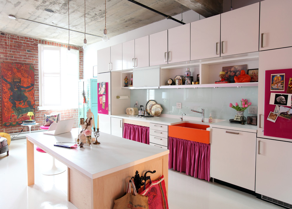 Eclectic single-wall open plan kitchen in Vancouver with a farmhouse sink, flat-panel cabinets, white cabinets, white splashback, glass sheet splashback and panelled appliances.