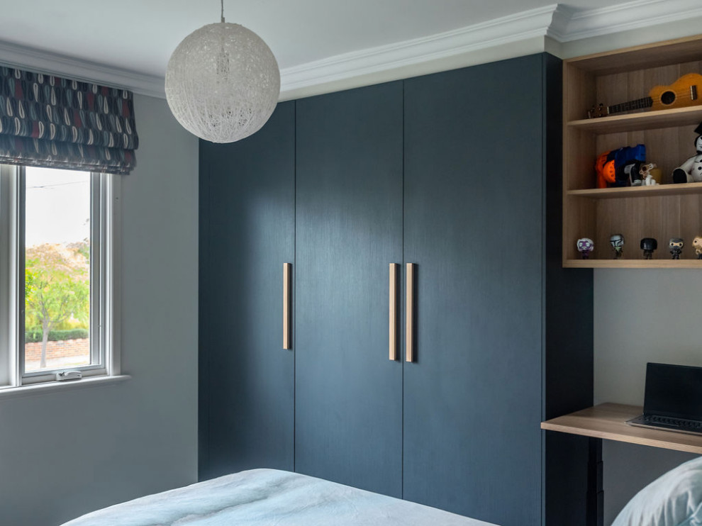 Contemporary gender neutral built-in wardrobe in Melbourne with open cabinets, dark wood cabinets, carpet and multi-coloured floors.