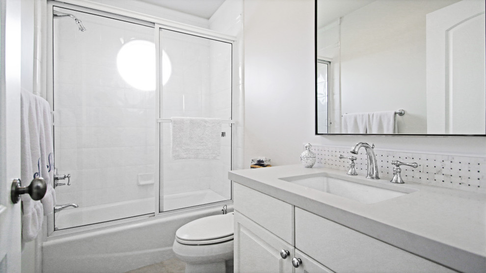 This is an example of a mid-sized contemporary 3/4 bathroom in Orange County with flat-panel cabinets, grey cabinets, black and white tile, subway tile, tile benchtops, grey benchtops, a double vanity and a built-in vanity.