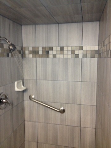 Small traditional 3/4 bathroom in Austin with a corner shower, beige tile, porcelain tile and an open shower.