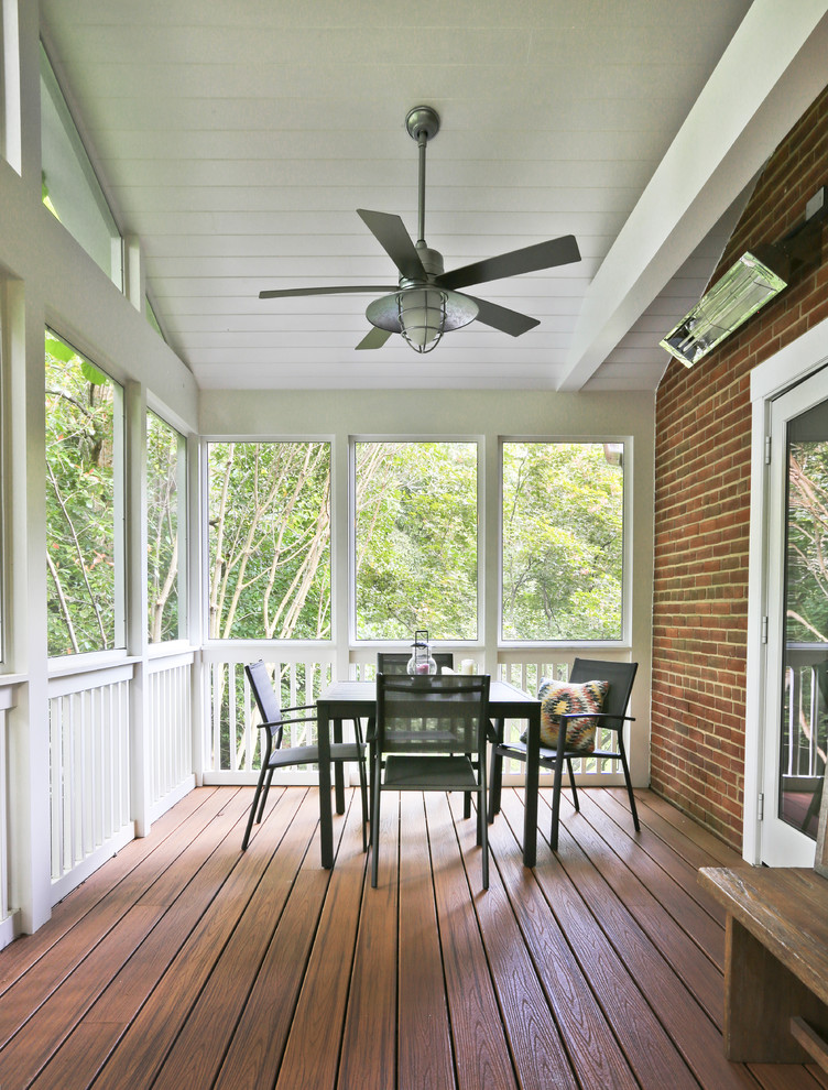 Design ideas for a mid-sized transitional side yard screened-in verandah in DC Metro with a roof extension.