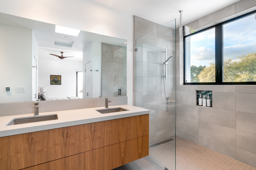 Design ideas for a mid-sized contemporary master bathroom in San Luis Obispo with flat-panel cabinets, medium wood cabinets, a curbless shower, white tile, ceramic tile, engineered quartz benchtops, an open shower, grey benchtops, a double vanity and a floating vanity.
