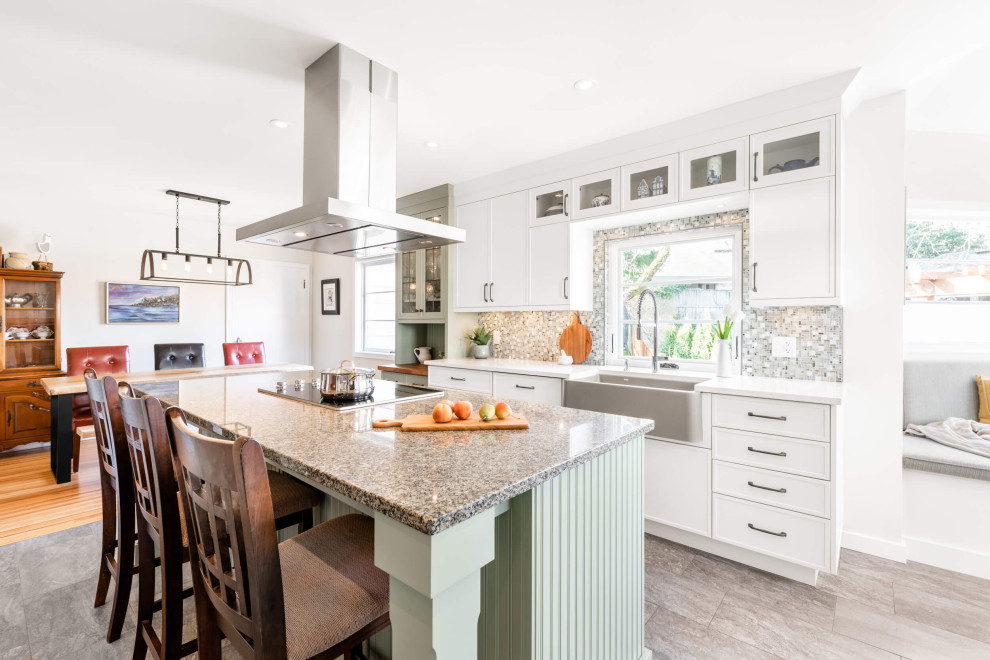 Inspiration for a mid-sized transitional galley gray floor eat-in kitchen remodel with shaker cabinets, an island, a farmhouse sink, white cabinets, gray backsplash and white countertops
