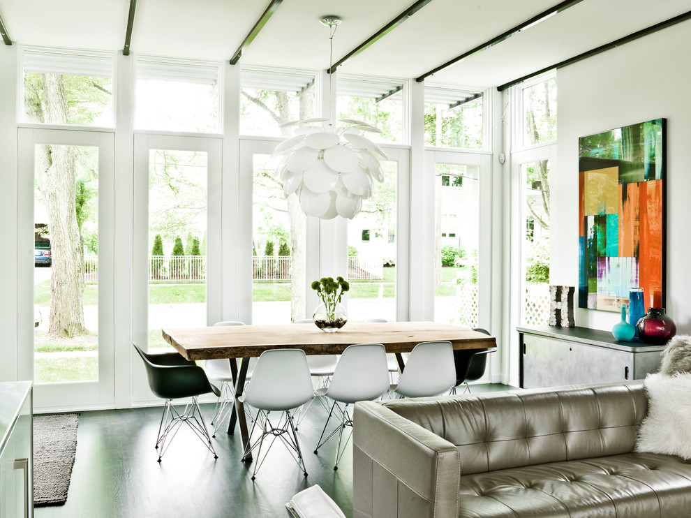 This is an example of a contemporary open plan dining in Chicago with white walls and dark hardwood floors.