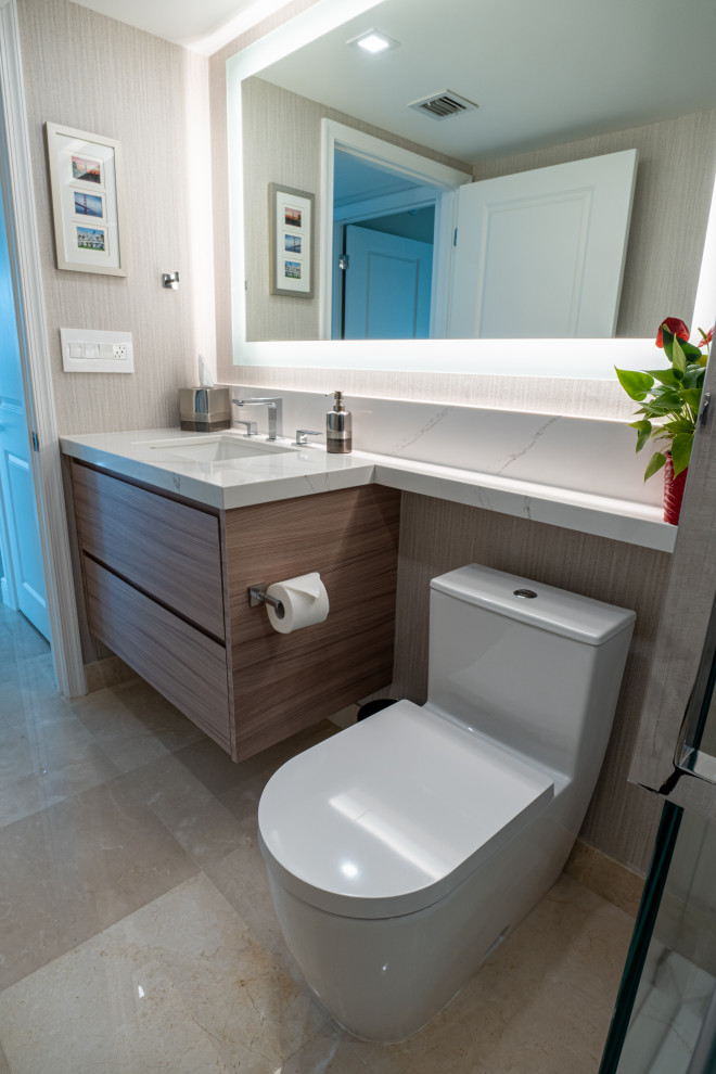 Photo of a medium sized modern shower room bathroom in Miami with flat-panel cabinets, light wood cabinets, an alcove shower, a two-piece toilet, multi-coloured tiles, stone slabs, beige walls, marble flooring, a submerged sink, engineered stone worktops, beige floors, a sliding door, beige worktops, a wall niche, a single sink, a floating vanity unit and wallpapered walls.