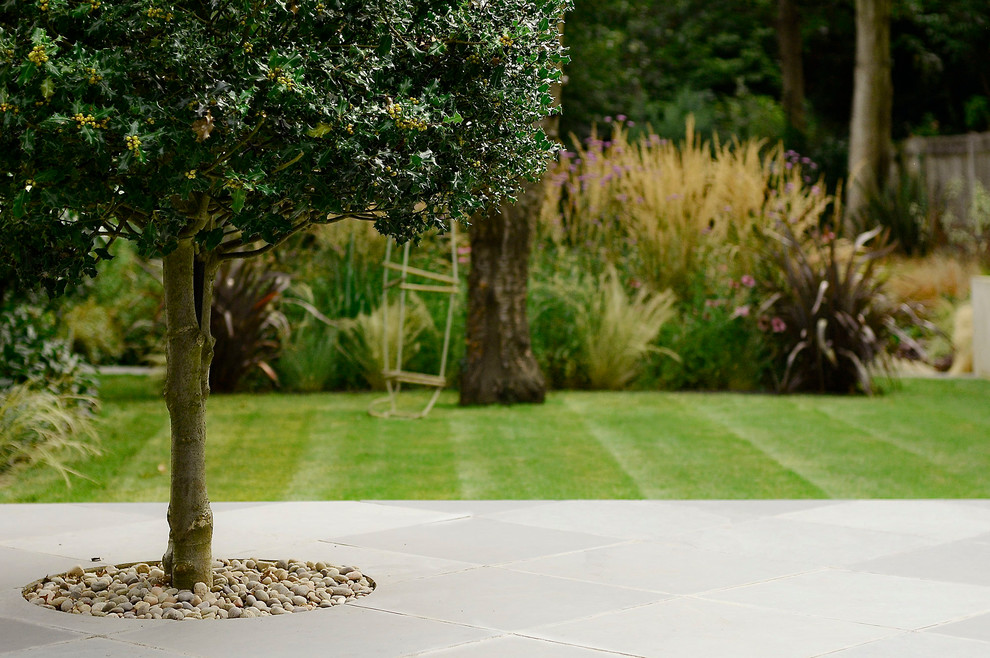 Design ideas for a contemporary garden in London with natural stone pavers.