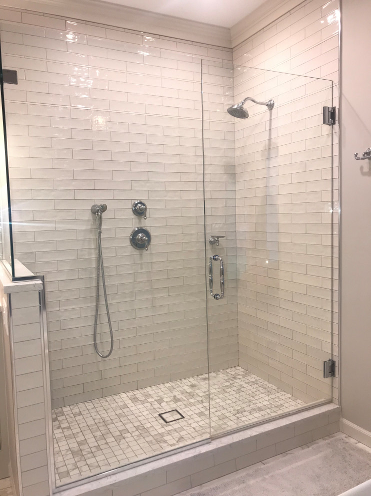 Design ideas for a mid-sized traditional master bathroom in San Francisco with shaker cabinets, grey cabinets, a corner shower, gray tile, subway tile, grey walls, marble floors, an undermount sink, granite benchtops, grey floor, a hinged shower door and grey benchtops.