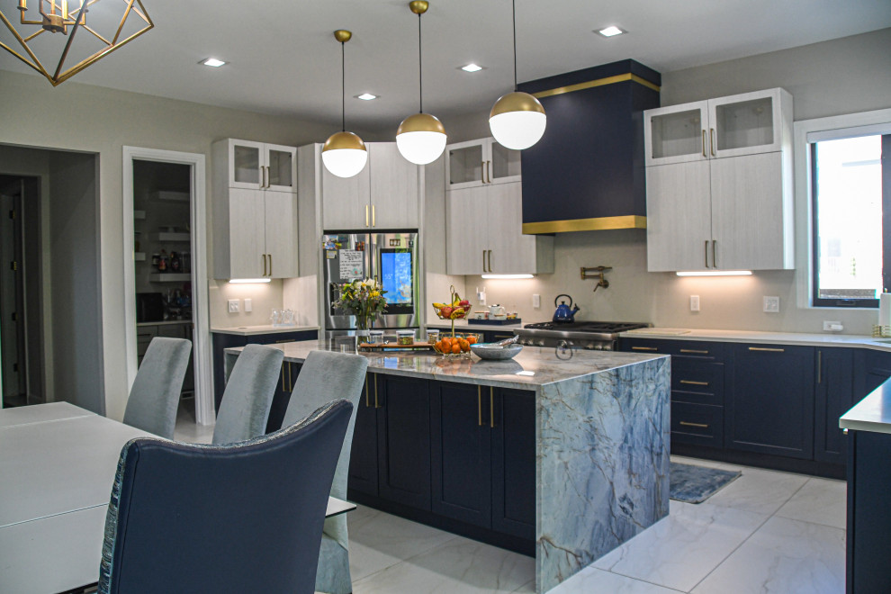Large contemporary u-shaped eat-in kitchen in Detroit with an undermount sink, flat-panel cabinets, blue cabinets, marble benchtops, stainless steel appliances, porcelain floors, with island, white floor and blue benchtop.