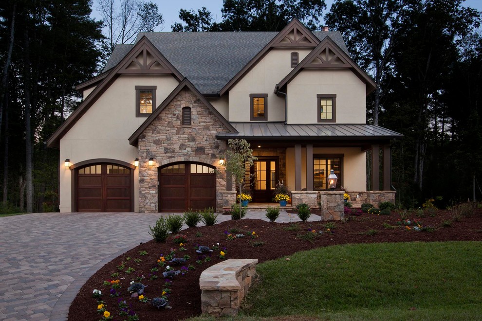 Inspiration for a large transitional three-storey stucco beige house exterior in Other with a gable roof and a shingle roof.