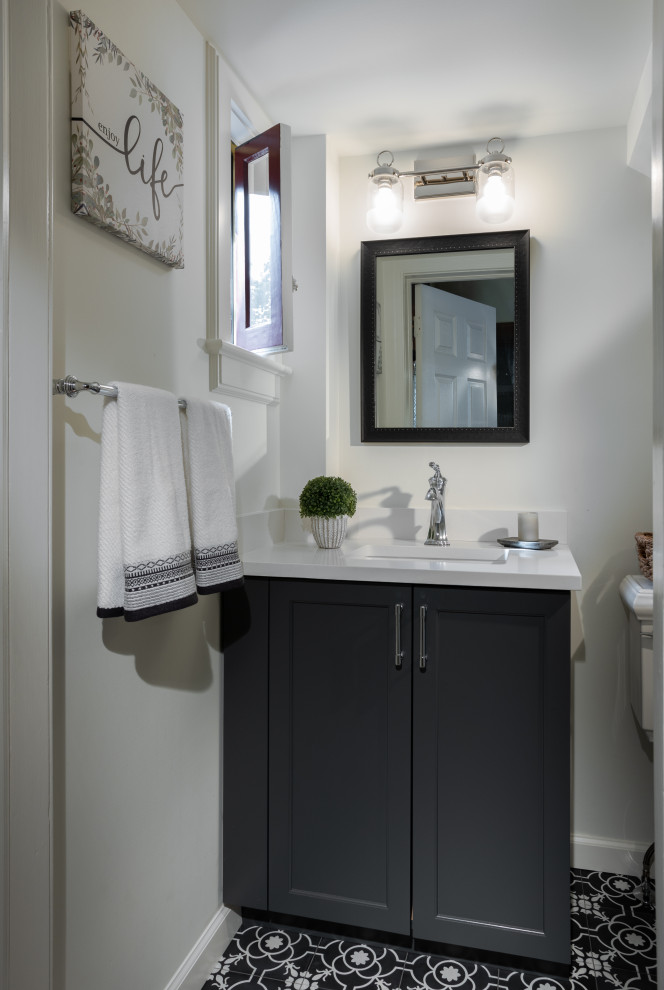Inspiration for a small modern shower room bathroom in Other with beaded cabinets, black cabinets, a two-piece toilet, white walls, cement flooring, a submerged sink, solid surface worktops, white worktops, a single sink and a built in vanity unit.