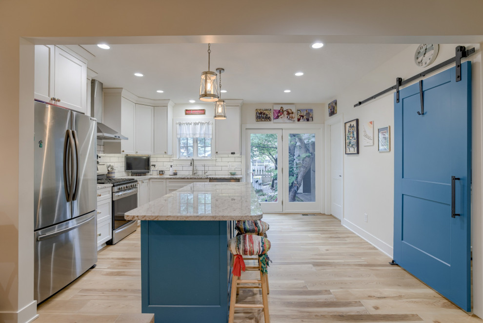 Eat-in kitchen - small transitional l-shaped eat-in kitchen idea with recessed-panel cabinets, turquoise cabinets, quartz countertops and an island