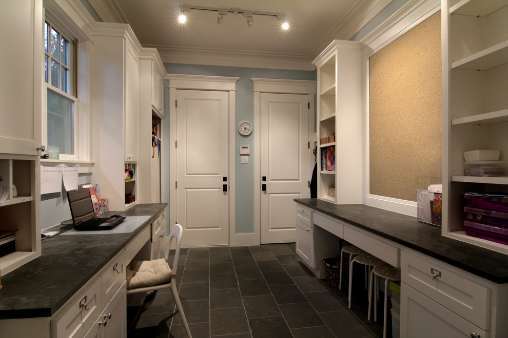 Traditional laundry room in Houston with grey floor.