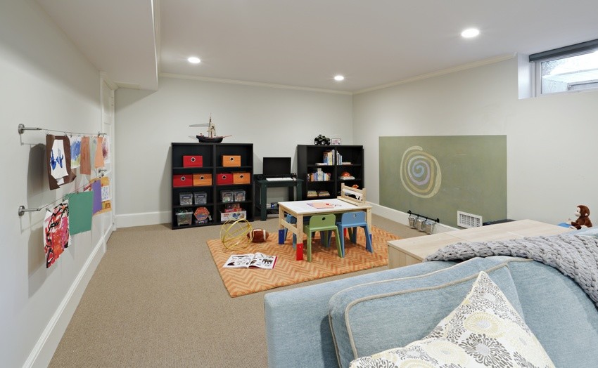This is an example of a large transitional look-out basement in New York with blue walls and carpet.