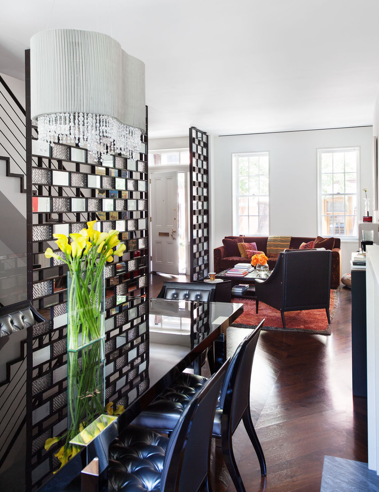 This is an example of a contemporary open plan dining in New York with white walls and dark hardwood floors.