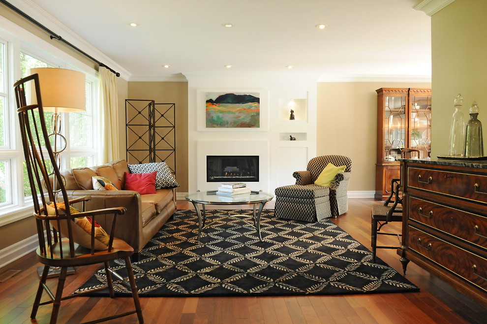 This is an example of a contemporary living room in Toronto with beige walls and a ribbon fireplace.