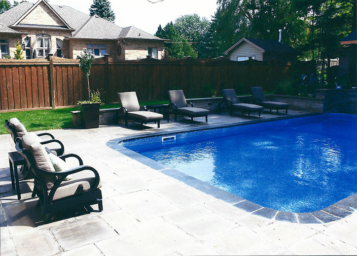 Inspiration for a large transitional backyard stone and rectangular pool remodel in Toronto