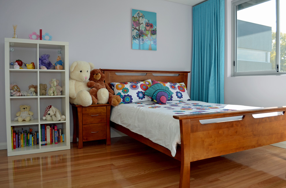 Inspiration for a modern kids' bedroom for kids 4-10 years old and girls in Perth with grey walls and medium hardwood floors.