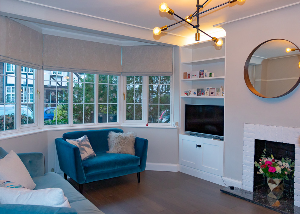 Medium sized eclectic living room in Surrey with grey walls, dark hardwood flooring and a brick fireplace surround.