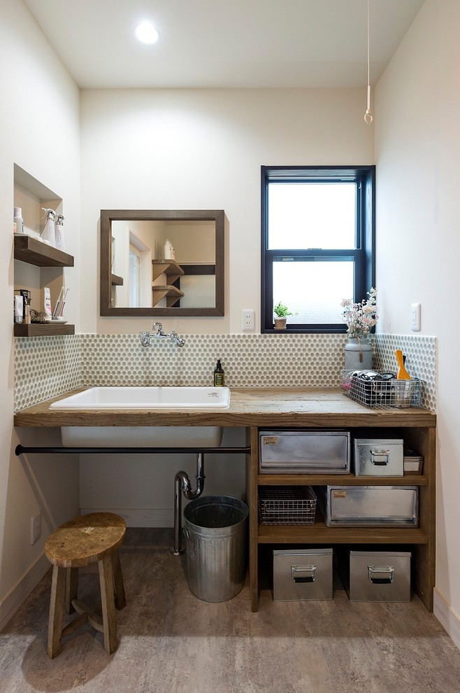 Inspiration for an industrial powder room in Other with open cabinets, distressed cabinets, white walls, painted wood floors, a drop-in sink, wood benchtops and grey floor.