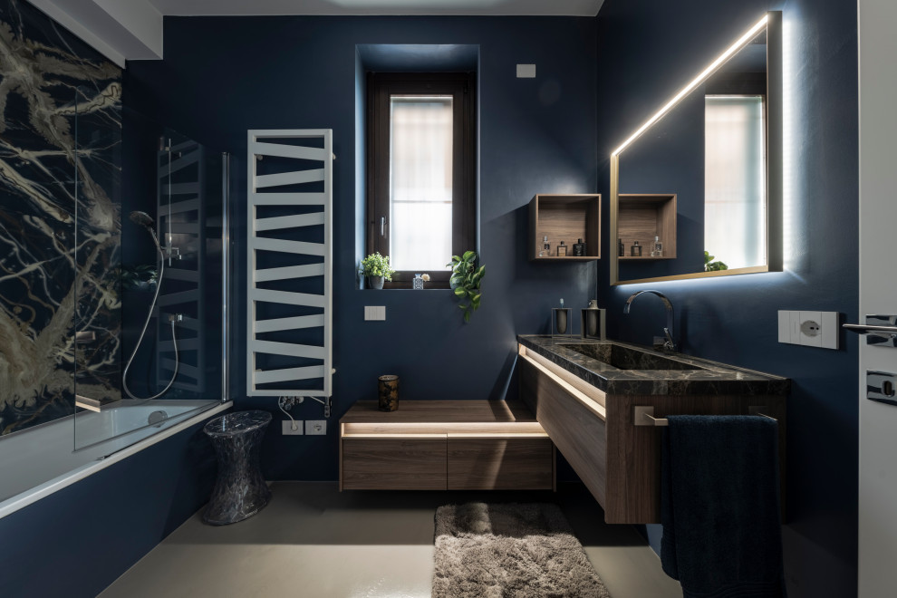Example of a mid-sized minimalist master gray floor, single-sink and wall paneling alcove shower design in Milan with flat-panel cabinets, brown cabinets, a two-piece toilet, blue walls, a drop-in sink, marble countertops, brown countertops and a floating vanity