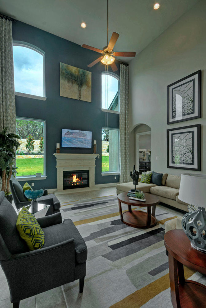 Photo of a large transitional open concept family room in Austin with porcelain floors, a standard fireplace, a concrete fireplace surround, a wall-mounted tv and multi-coloured walls.