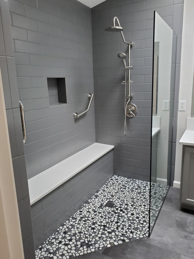 This is an example of a mid-sized modern master bathroom in Portland with shaker cabinets, grey cabinets, an open shower, gray tile, ceramic tile, white walls, pebble tile floors, an undermount sink, engineered quartz benchtops, grey floor, white benchtops, a shower seat, a double vanity and a built-in vanity.