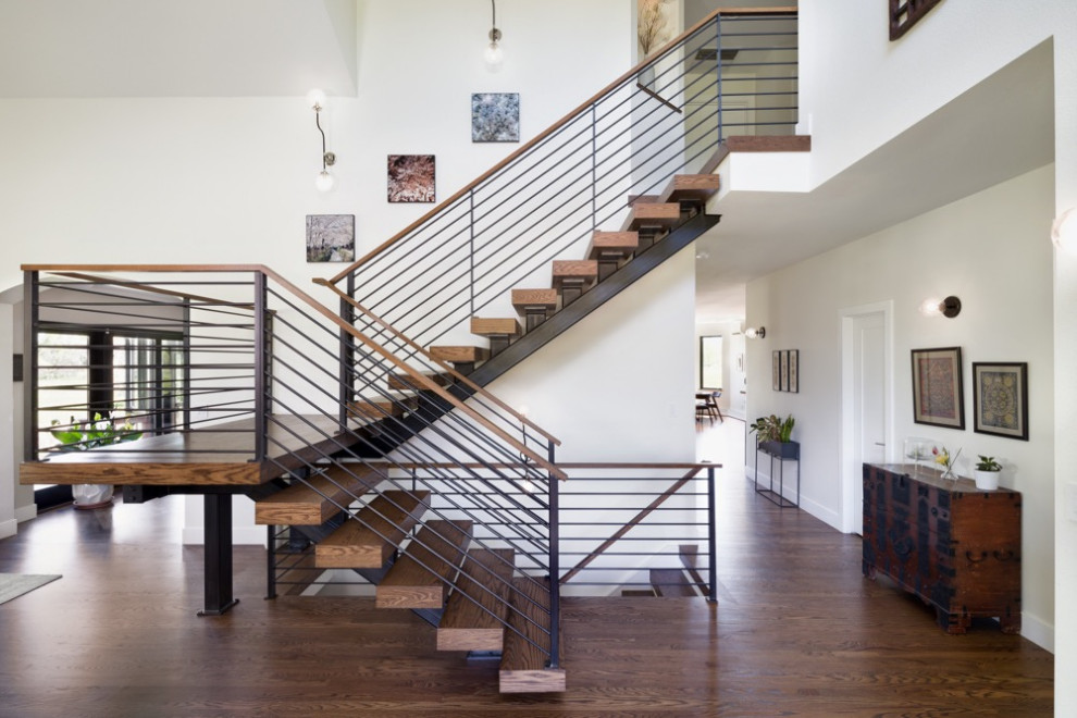 This is an example of a mid-sized midcentury metal l-shaped staircase in Denver with metal risers and wood railing.