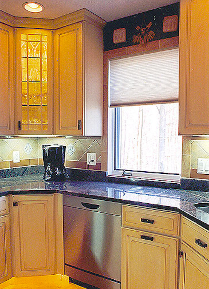 Mid-sized kitchen photo in DC Metro with a double-bowl sink, light wood cabinets, beige backsplash and stainless steel appliances