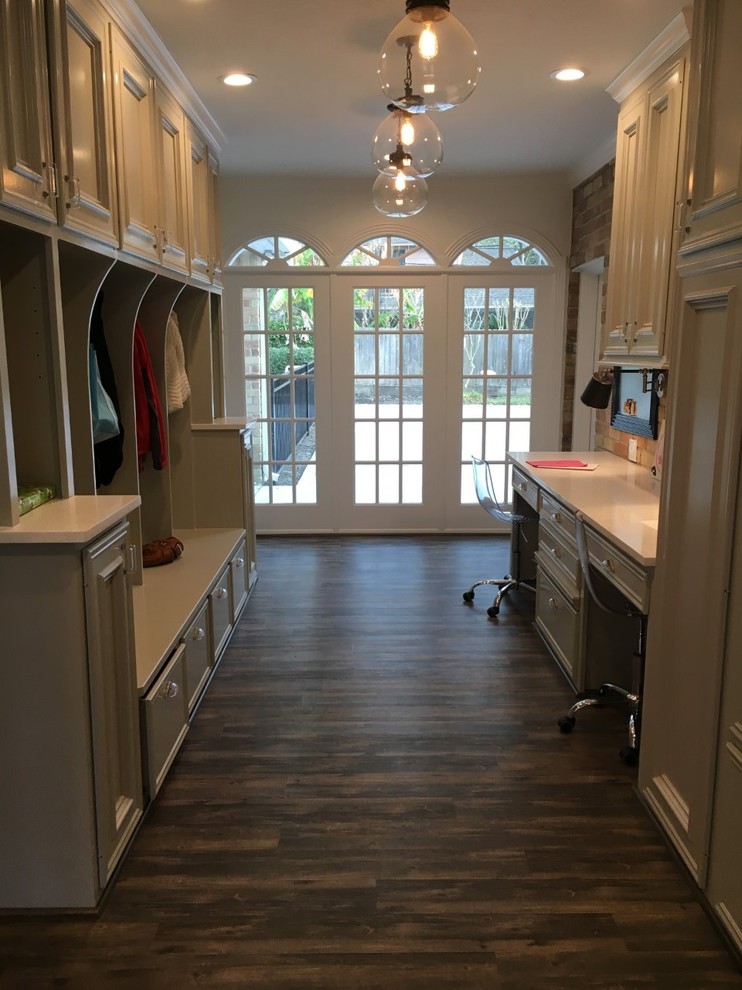 Inspiration for a transitional utility room in Houston with dark hardwood floors and a side-by-side washer and dryer.