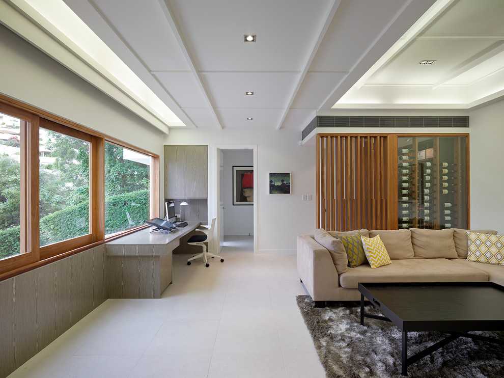 Photo of a contemporary study room in Brisbane with white walls, concrete floors, no fireplace and a built-in desk.