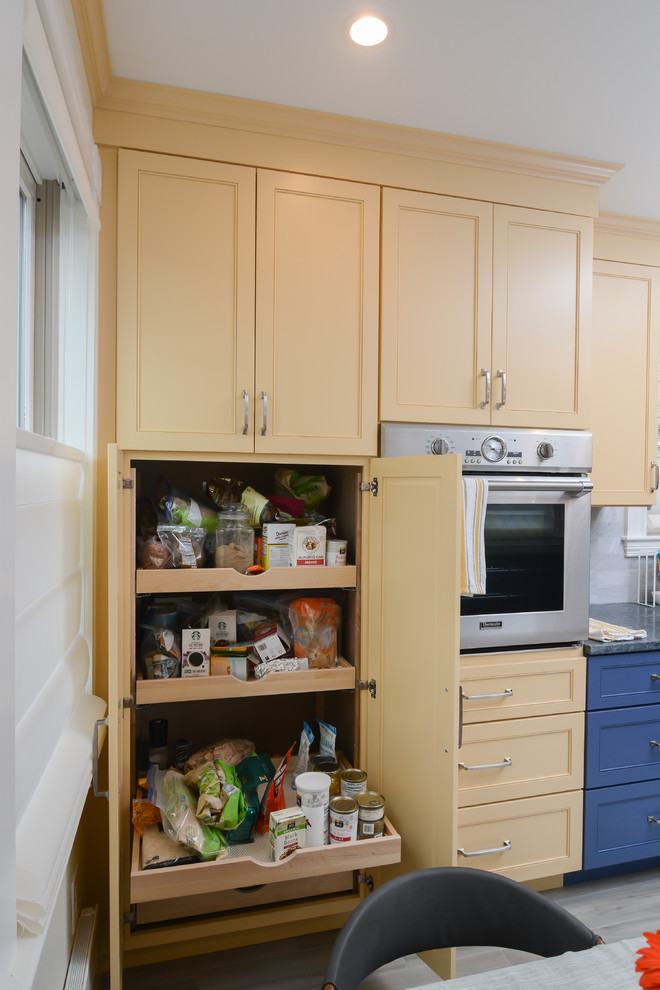 Photo of a mid-sized transitional eat-in kitchen in Boston with beaded inset cabinets, blue cabinets, soapstone benchtops, stainless steel appliances, ceramic floors, no island, grey floor and grey benchtop.
