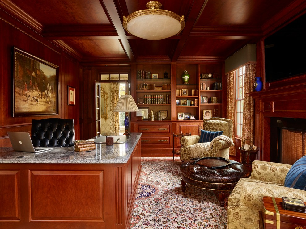 This is an example of a traditional study room in Philadelphia with brown walls, carpet, a standard fireplace and a built-in desk.