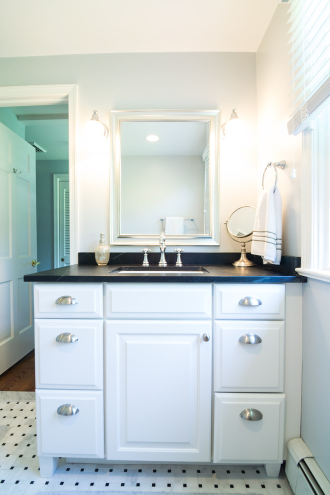 Design ideas for a small traditional master bathroom in Philadelphia with raised-panel cabinets, white cabinets, an alcove shower, black and white tile, stone tile, white walls, an undermount sink, soapstone benchtops and black benchtops.