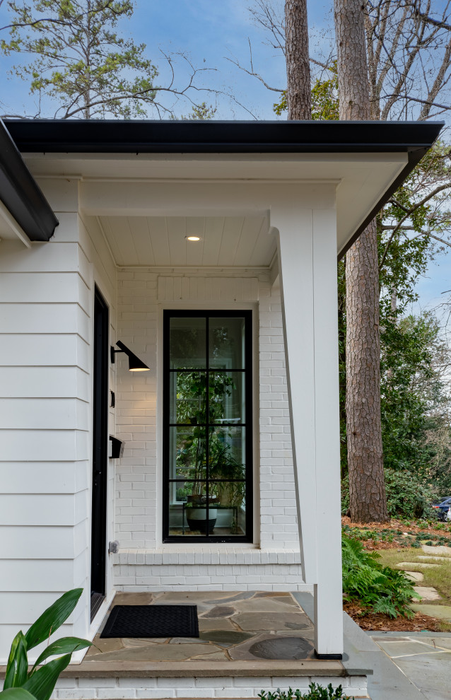 Photo of a mid-sized transitional front door in Atlanta with a single front door and brick walls.