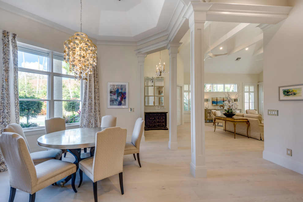 Great room - transitional light wood floor, beige floor and vaulted ceiling great room idea with white walls and no fireplace