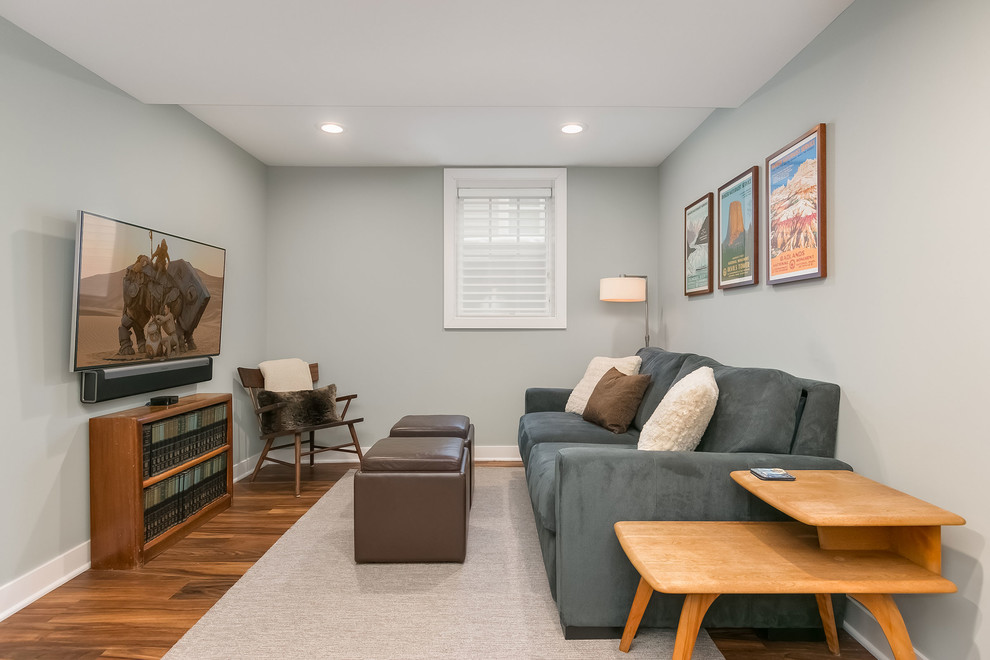Inspiration for a large transitional look-out basement in Minneapolis with grey walls, medium hardwood floors, no fireplace and brown floor.