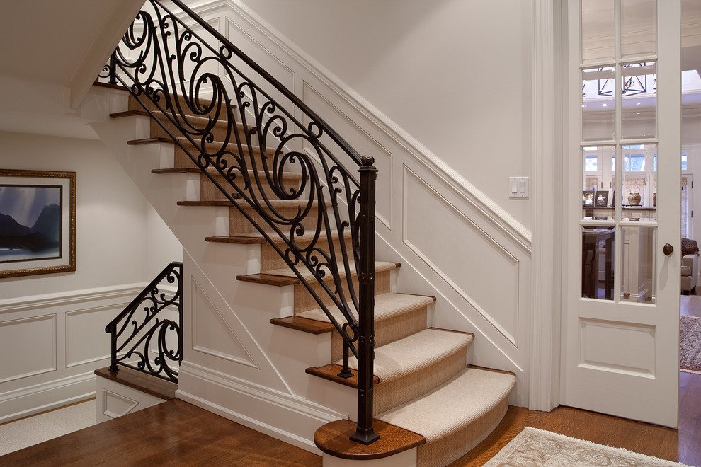 This is an example of a traditional staircase in Toronto with metal railing.