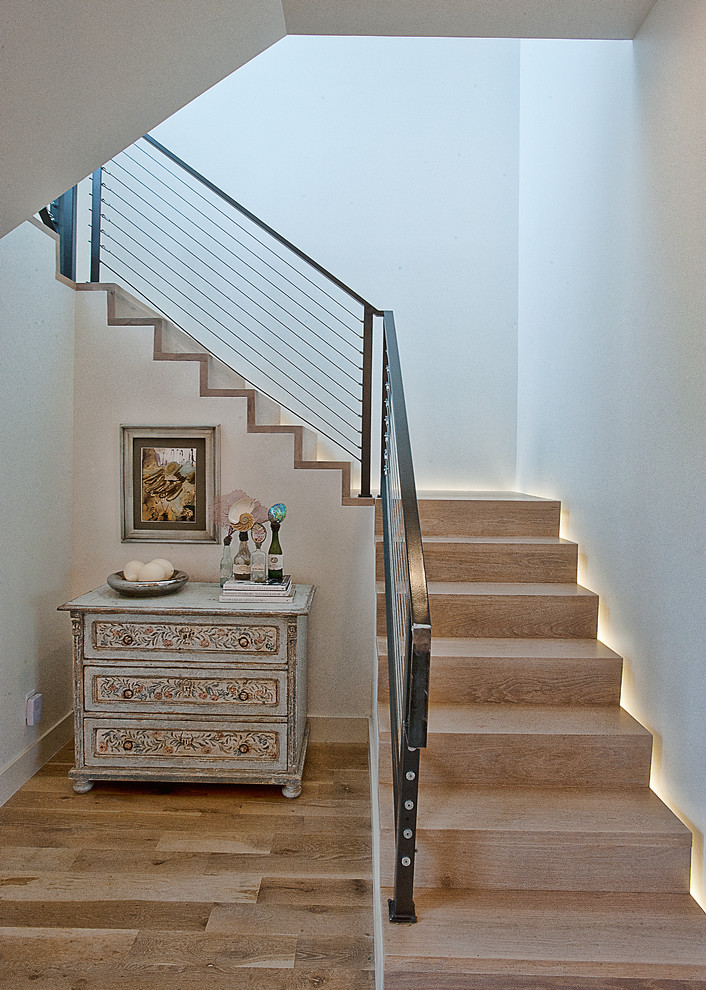 Photo of a transitional wood staircase in Austin with wood risers and cable railing.