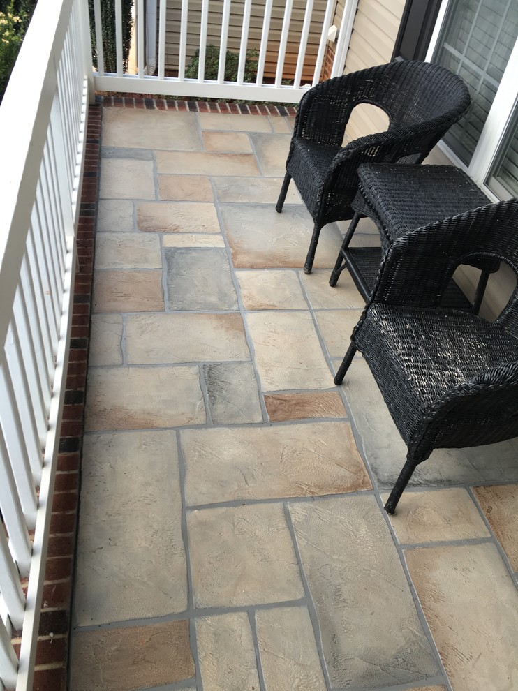 This is an example of a mid-sized traditional backyard deck in Other with no cover.