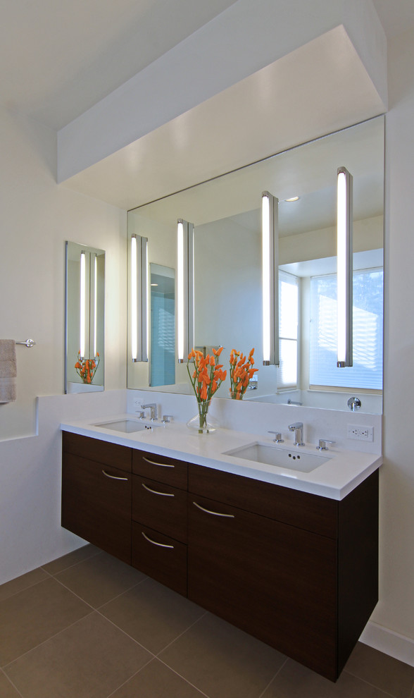 Photo of a mid-sized modern master bathroom in San Francisco with an undermount sink, flat-panel cabinets, medium wood cabinets, glass benchtops, an alcove tub, a corner shower, a wall-mount toilet, beige tile, porcelain tile, yellow walls and porcelain floors.